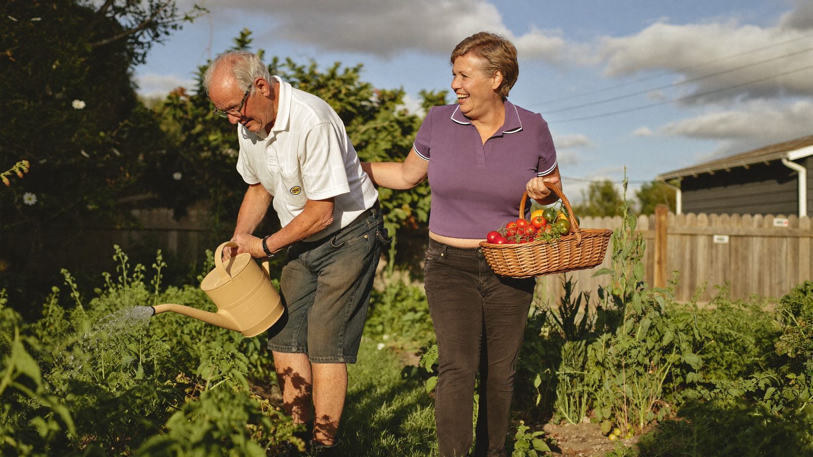 An older Australian tending the garden alongside a friendly Divine Care carer